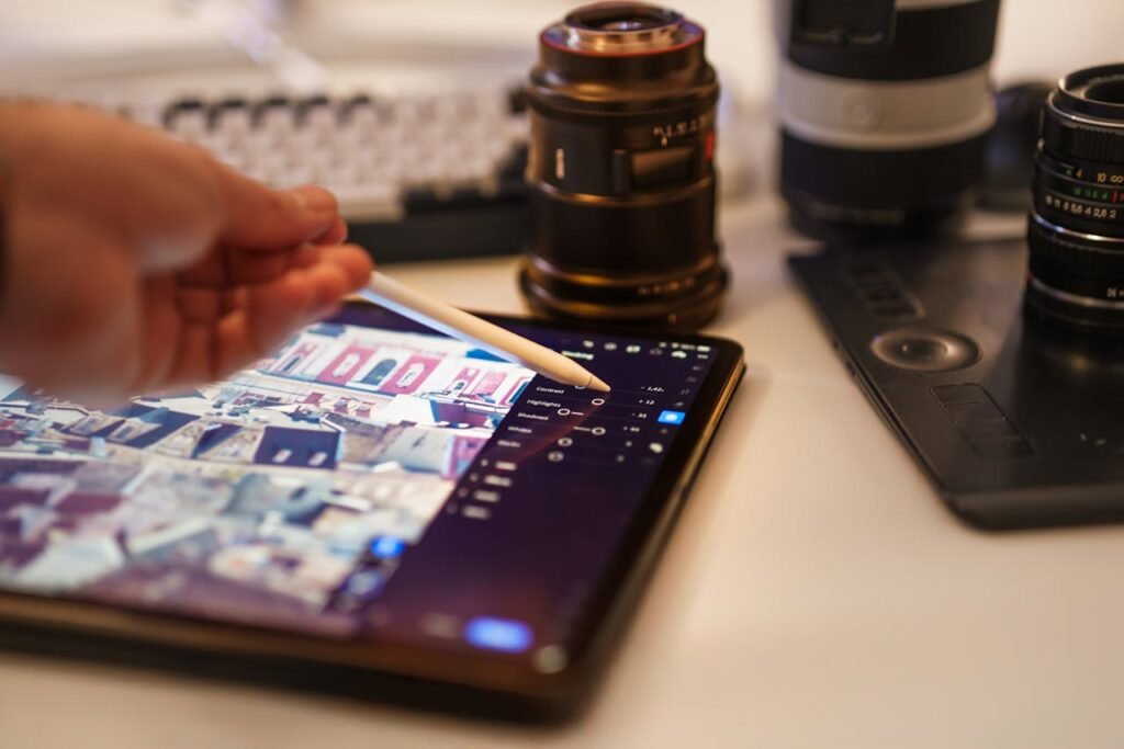 pexels photo 31313716 A detailed view of a professional photography editing setup with tablet and lenses.